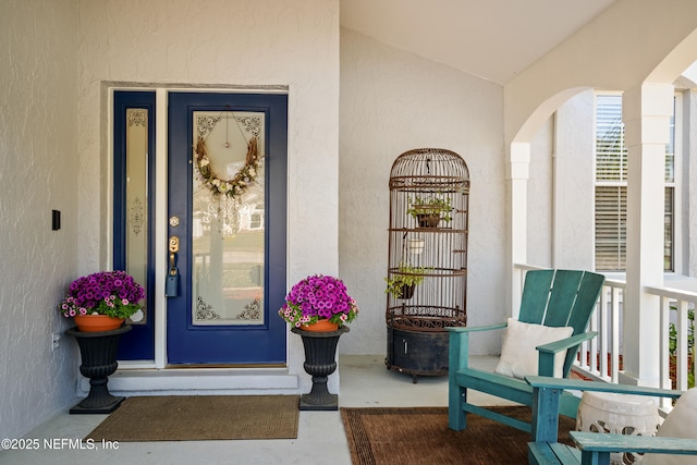 property entrance with stucco siding