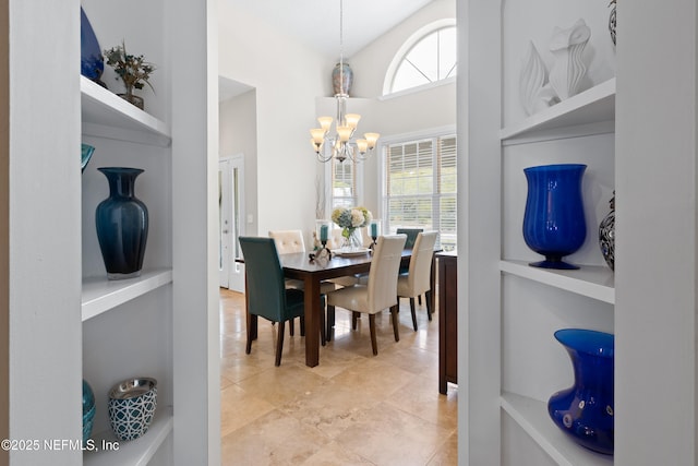 dining space with an inviting chandelier