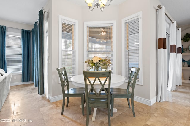 dining space featuring an inviting chandelier, light tile patterned flooring, and baseboards