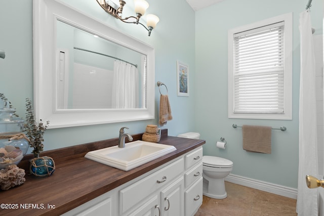 bathroom with vanity, baseboards, tile patterned flooring, curtained shower, and toilet