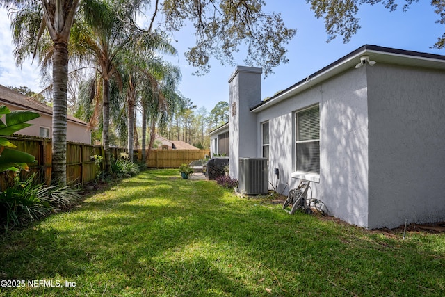 view of yard featuring central air condition unit and a fenced backyard