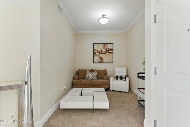 sitting room with visible vents, baseboards, ornamental molding, and carpet flooring