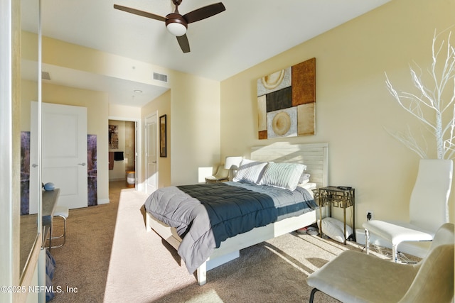 carpeted bedroom with visible vents and ceiling fan