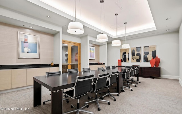 office featuring baseboards, recessed lighting, french doors, a raised ceiling, and light colored carpet