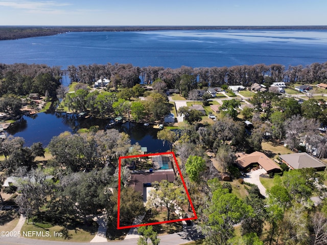 birds eye view of property with a water view