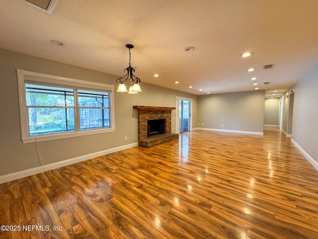 unfurnished living room featuring visible vents, recessed lighting, baseboards, and wood finished floors