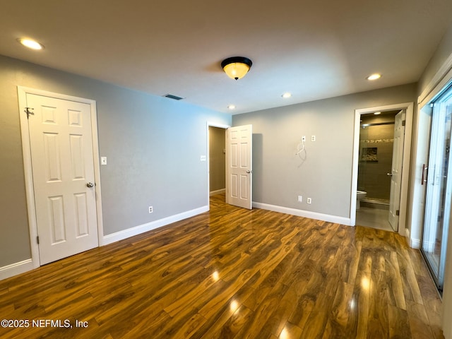 unfurnished bedroom with dark wood finished floors, recessed lighting, baseboards, and visible vents