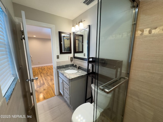 bathroom featuring visible vents, toilet, vanity, and tile patterned flooring