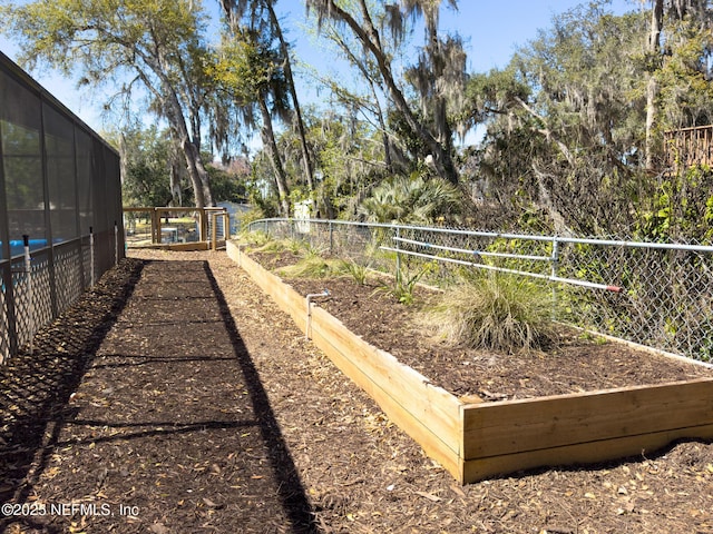 surrounding community with a vegetable garden and fence