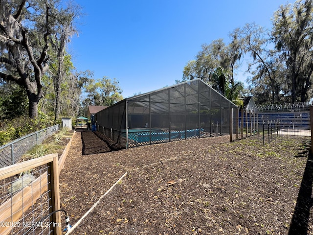 view of yard with a fenced in pool, a lanai, and fence