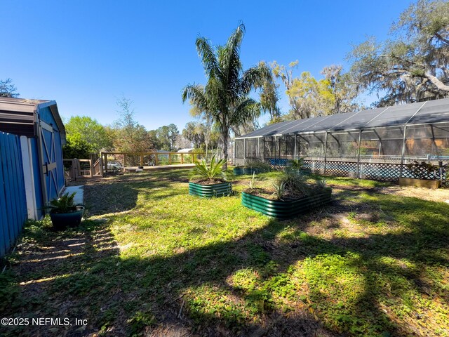 view of yard featuring an exterior structure and a vegetable garden