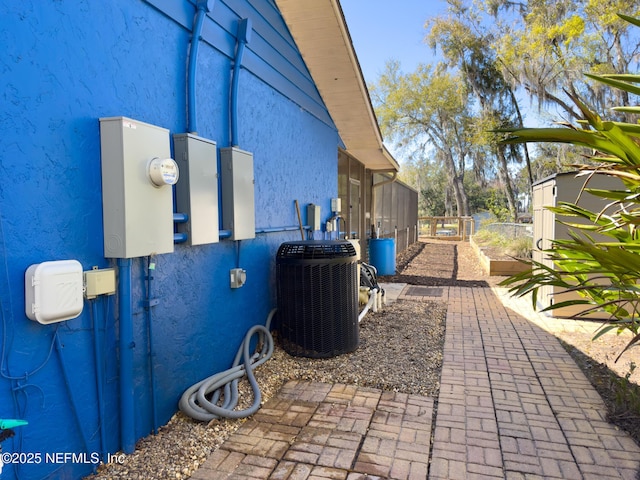 view of patio / terrace with central air condition unit and fence