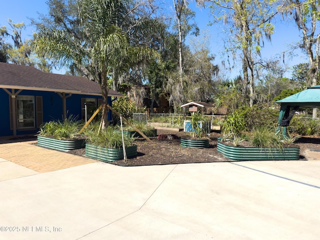 exterior space with a gazebo and a garden