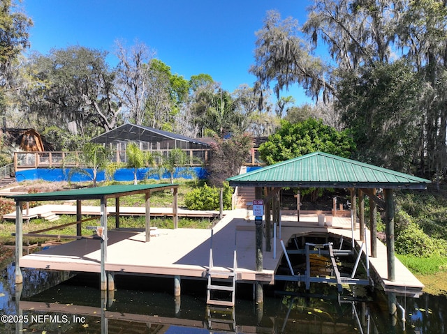 view of dock with glass enclosure, a water view, and boat lift