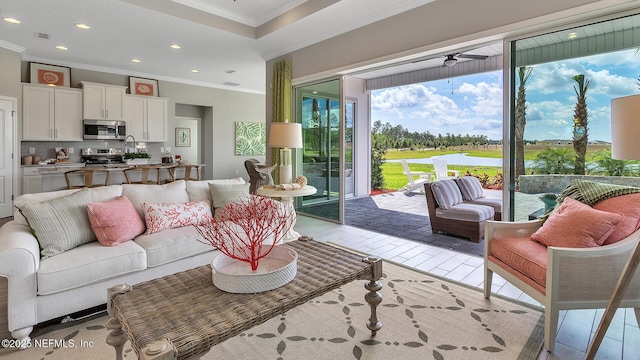 living area featuring recessed lighting, visible vents, a ceiling fan, and crown molding