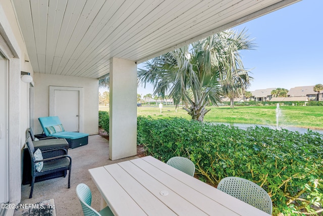 view of patio with outdoor dining space and a water view