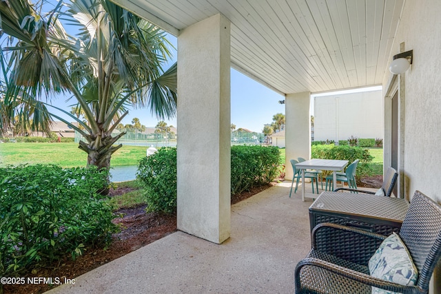 view of patio / terrace with outdoor dining space and a water view