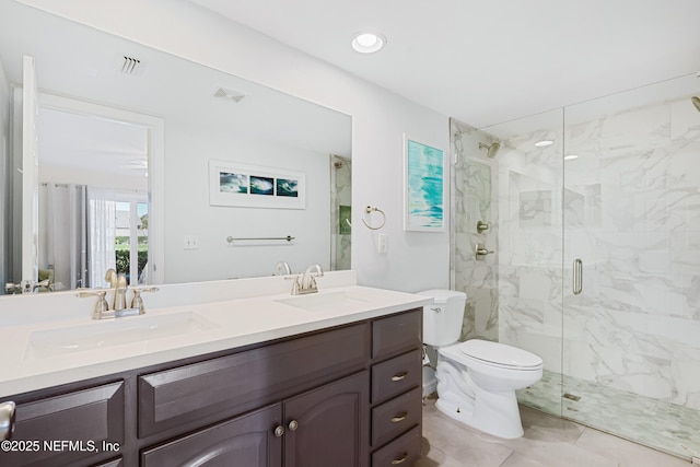 full bathroom featuring toilet, visible vents, a marble finish shower, and a sink