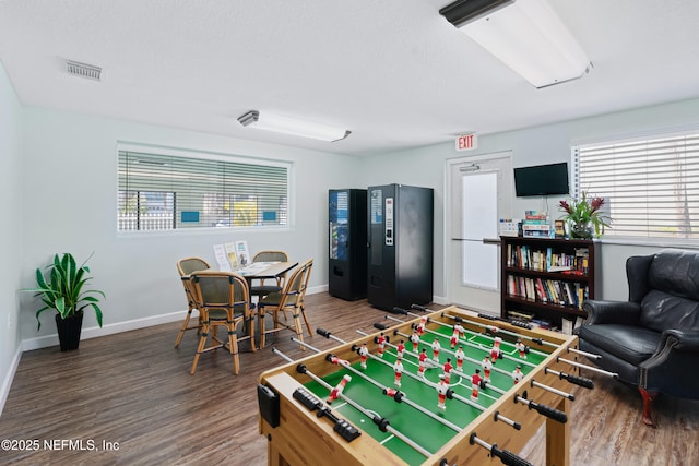 playroom featuring visible vents, baseboards, and wood finished floors