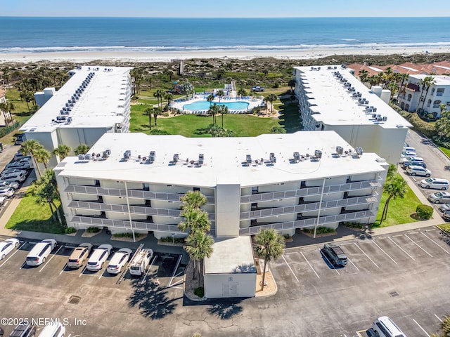 bird's eye view featuring a view of the beach and a water view