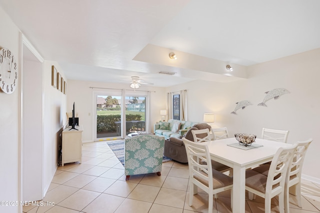 dining space with light tile patterned floors, visible vents, baseboards, and a ceiling fan