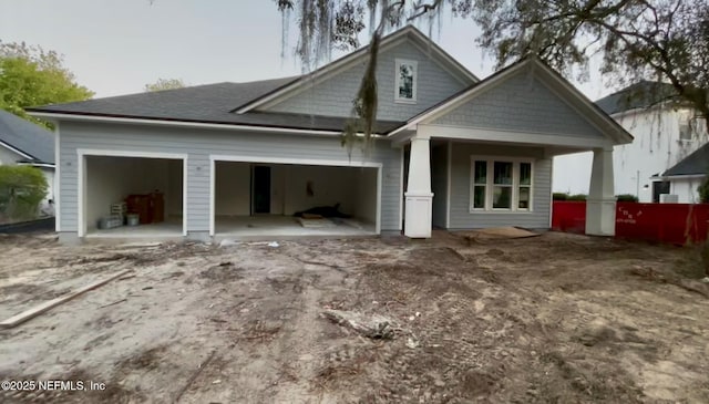 back of house featuring a garage