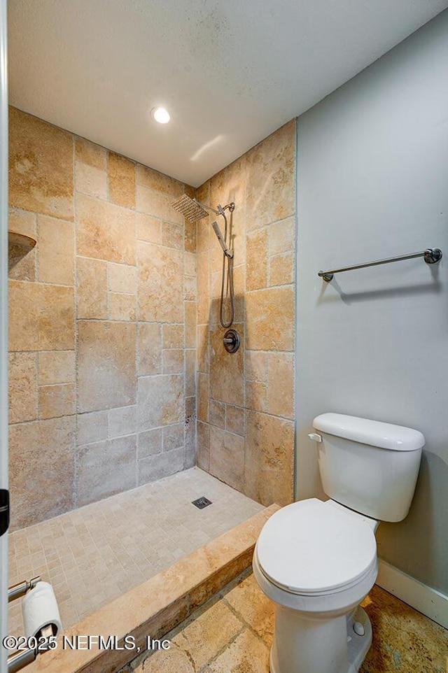 bathroom with recessed lighting, a shower stall, toilet, and baseboards