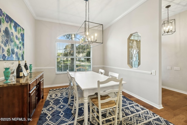 dining room featuring a notable chandelier, ornamental molding, baseboards, and dark wood-style flooring