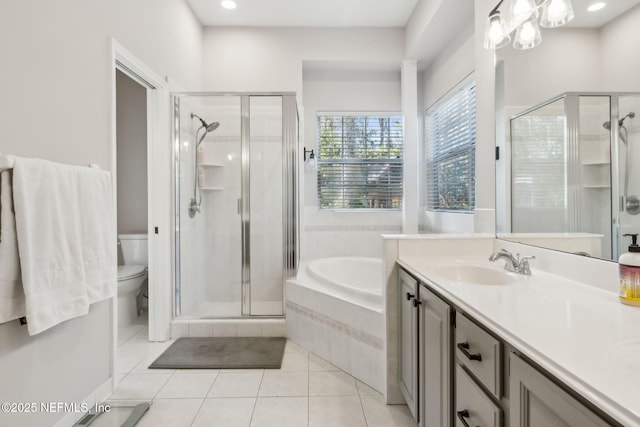 bathroom featuring tile patterned flooring, a shower stall, toilet, a bath, and a sink