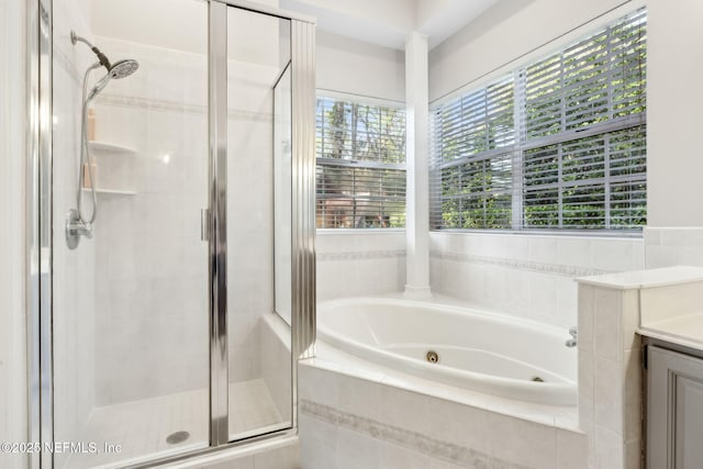 bathroom with vanity, a stall shower, and a whirlpool tub