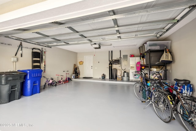 garage featuring electric panel and a garage door opener