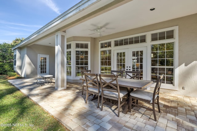 view of patio featuring outdoor dining space, french doors, and a ceiling fan