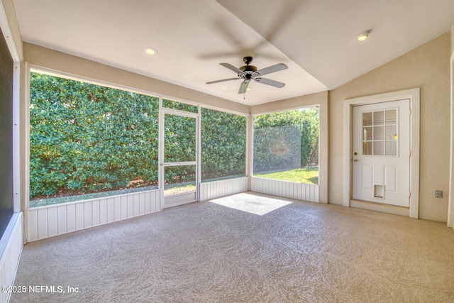 unfurnished sunroom featuring lofted ceiling, a healthy amount of sunlight, and ceiling fan