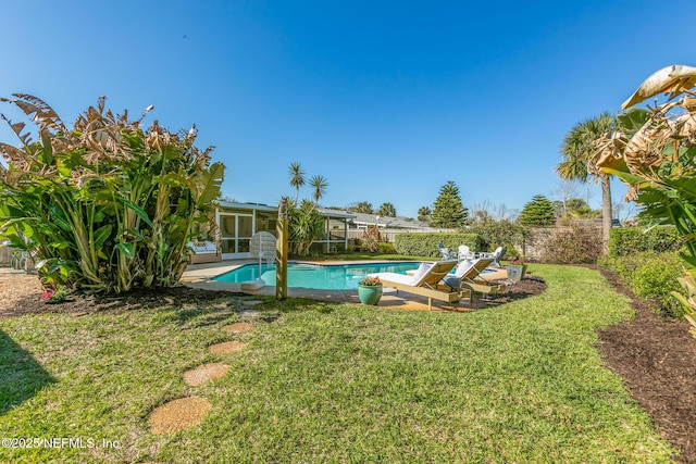 view of yard with a patio area, a fenced in pool, and a fenced backyard