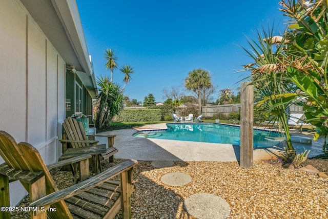 view of swimming pool featuring a fenced backyard, a fenced in pool, and a patio