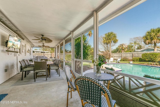 sunroom / solarium featuring a ceiling fan