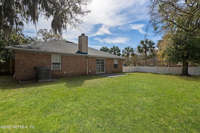 back of house featuring cooling unit, a lawn, and fence private yard