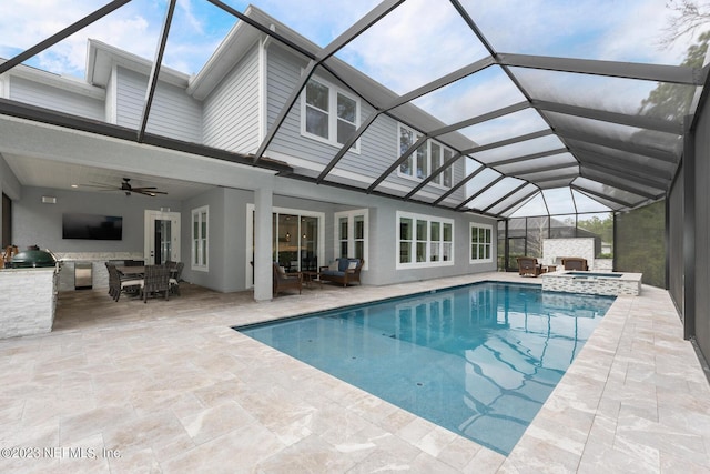 view of pool featuring a pool with connected hot tub, ceiling fan, a lanai, a grill, and a patio