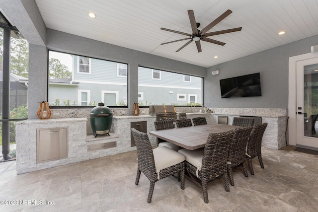 view of patio / terrace with grilling area, exterior kitchen, and a ceiling fan