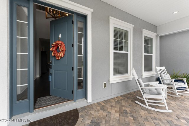 entrance to property with stucco siding