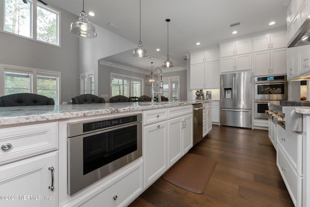 kitchen with visible vents, a healthy amount of sunlight, and stainless steel appliances