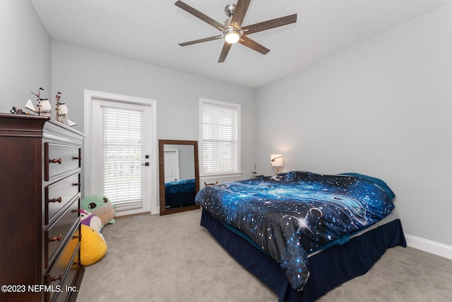 bedroom with baseboards, carpet floors, and a ceiling fan