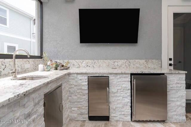 view of patio with an outdoor kitchen and a sink