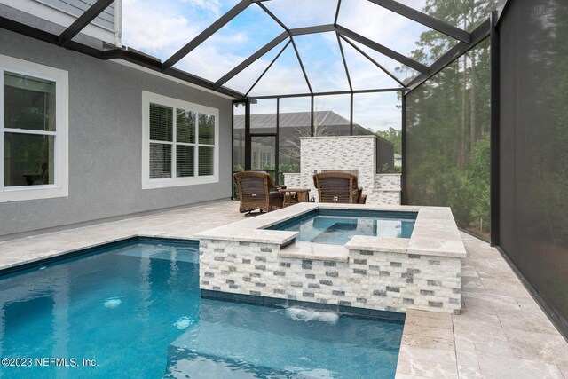 view of pool with a patio, an outdoor fireplace, and a pool with connected hot tub