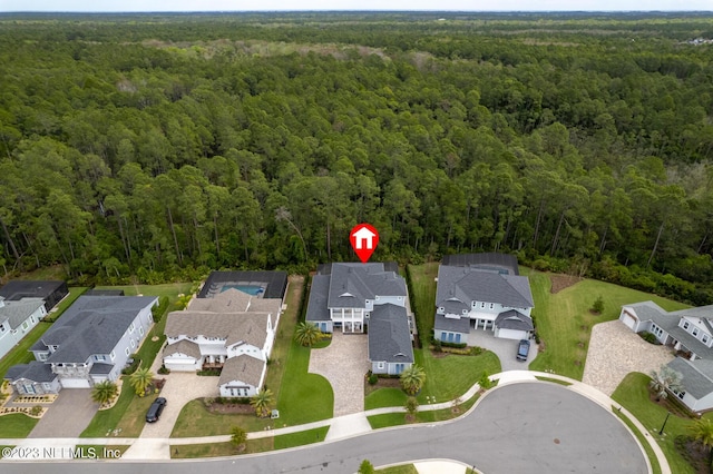 birds eye view of property with a residential view and a view of trees