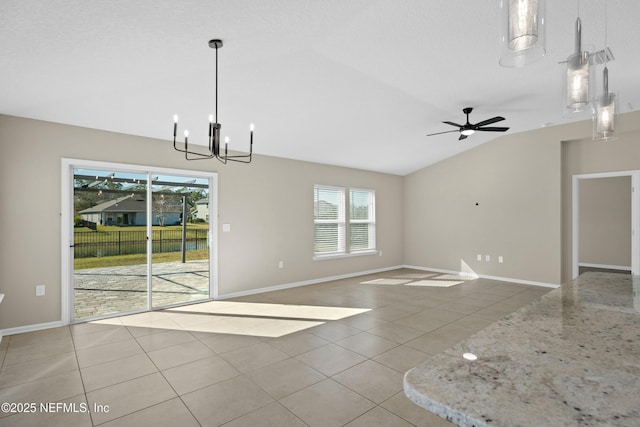 unfurnished dining area featuring light tile patterned floors, ceiling fan with notable chandelier, baseboards, and vaulted ceiling