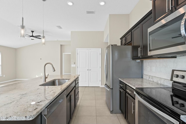 kitchen with light tile patterned floors, visible vents, a sink, decorative backsplash, and stainless steel appliances