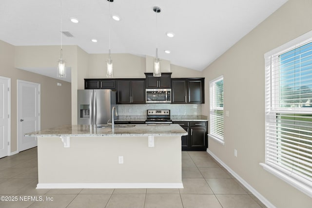 kitchen with visible vents, a kitchen island with sink, a sink, appliances with stainless steel finishes, and light tile patterned flooring