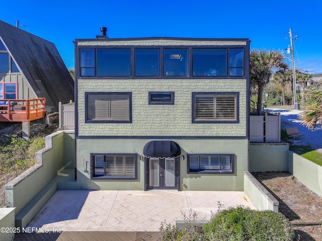 exterior space with a patio area and stucco siding