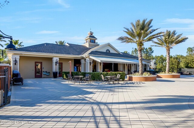 exterior space with stucco siding and a patio